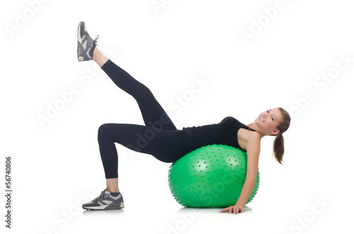 Young woman with ball exercising on whitee photo