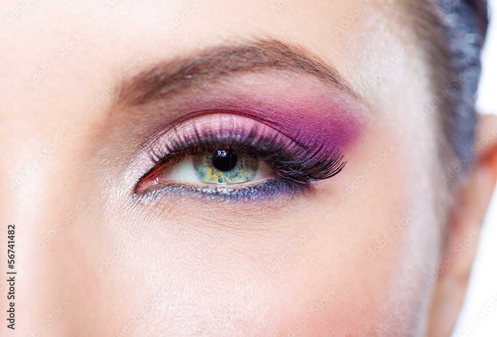 Obraz premium Close up of female eye with bright pink makeup
