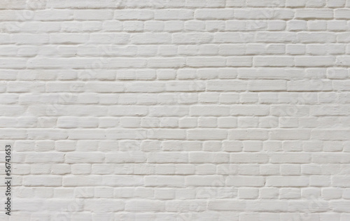 Background of vintage brick wall covered with white plaster