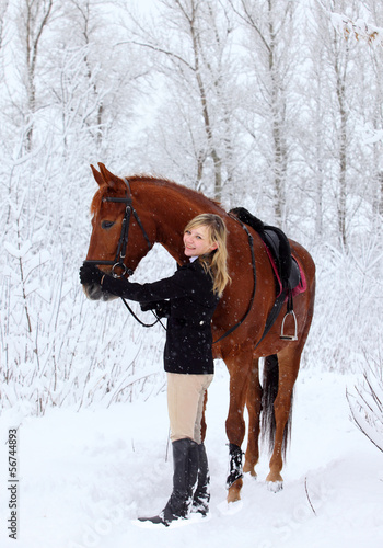 Happy girl fondles horse
