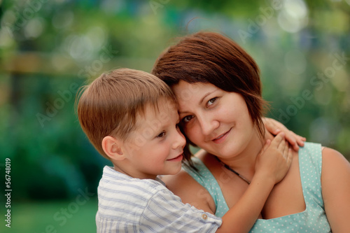 Portrait of an affectionate and loving mother kissing her baby s
