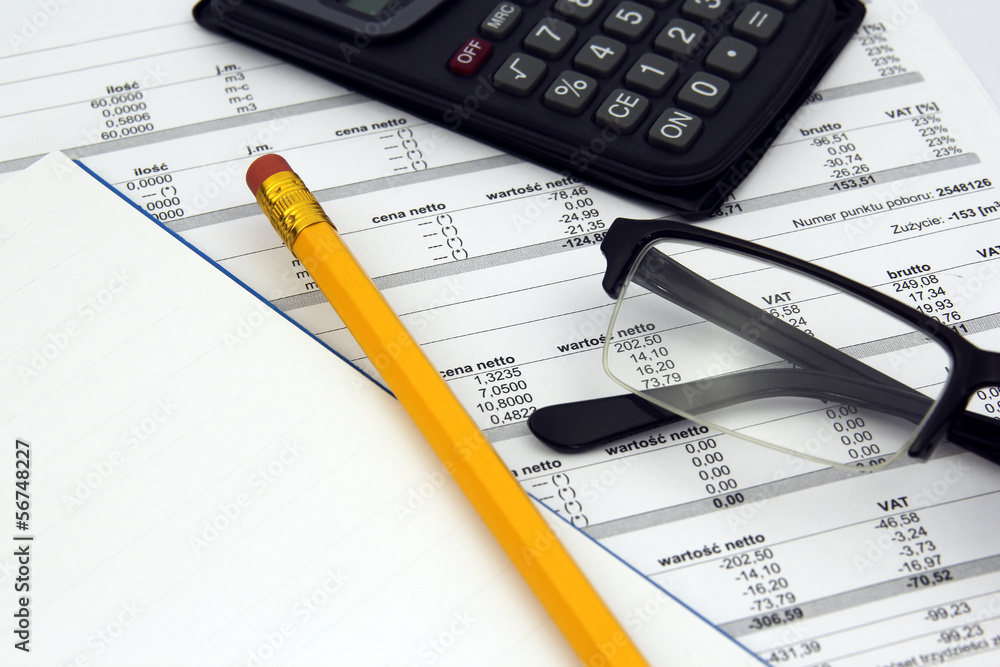 glasses, calculator and pencil on paper bills. concept of paying glasses, calculator and pencil on paper bills. concept of paying