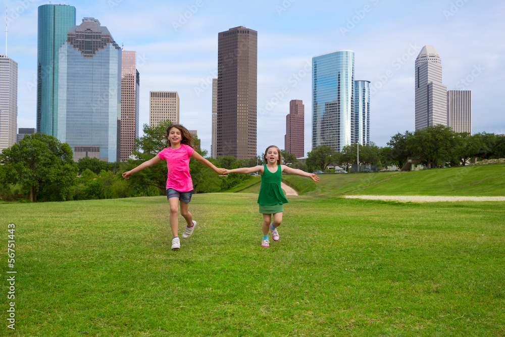 Two sister girls friends running holding hand in urban skyline