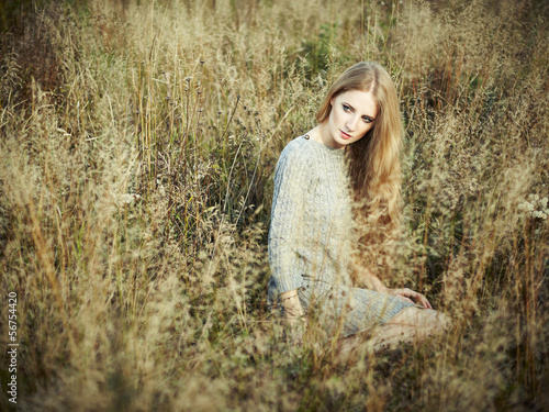 Portrait of beautiful woman on autumn field