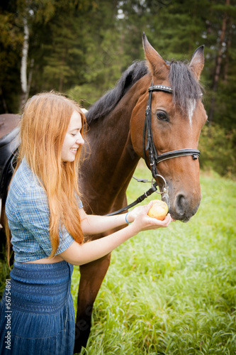 girl feeds a horse an apple © kalinina_alisa