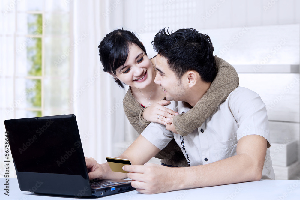 Happy asian couple online shoping at home Happy asian couple online shoping at home