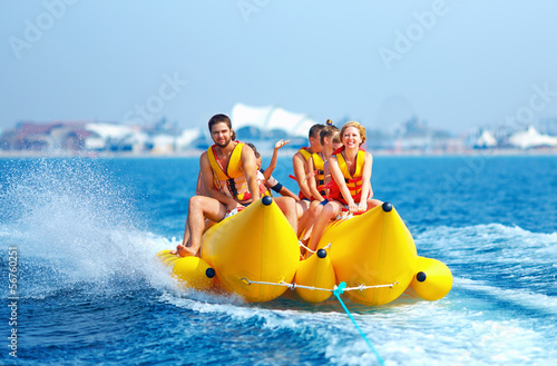 happy people having fun on banana boat