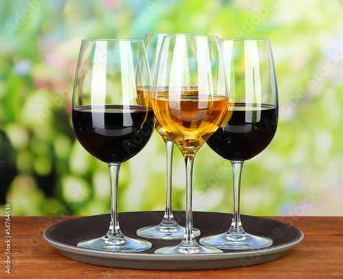 Glasses of wine, on bright background