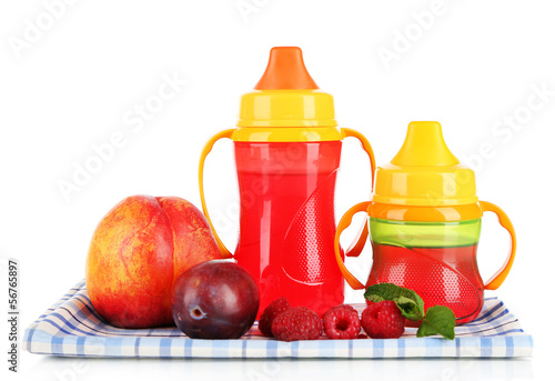Fototapeta Naklejka Na Ścianę i Meble -  Fruits and baby bottles with compote on napkin isolated on