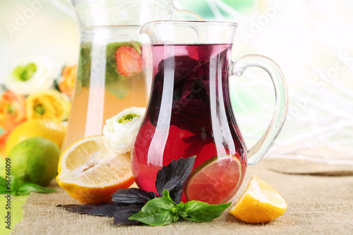 Red basil lemonade in jug and glass,