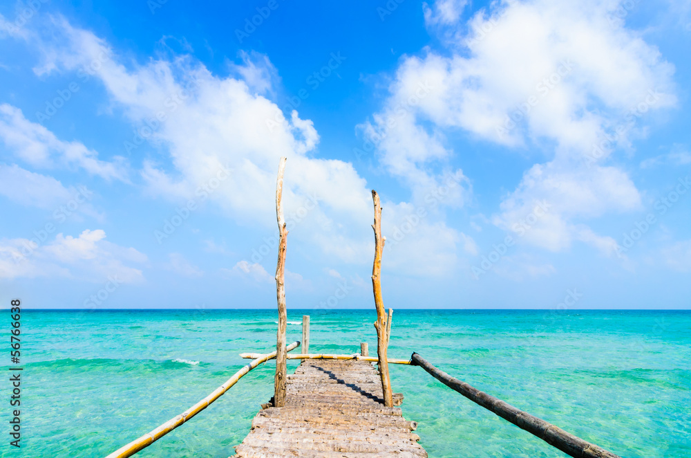 Wooden pier leading to sea on beautiful beach at Nam Du Island