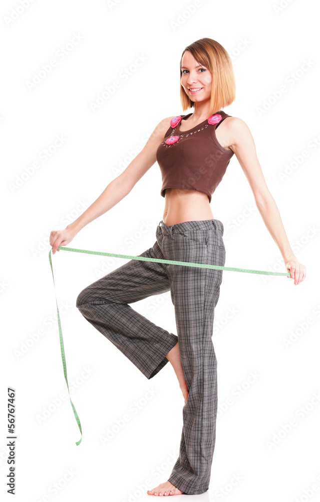 Beautiful young caucasian woman measuring her body with tape iso