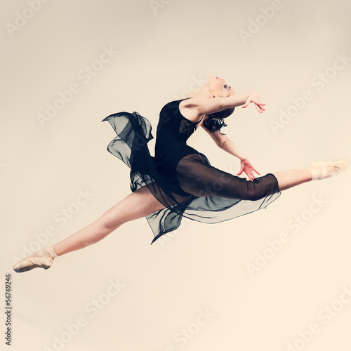 Beautiful ballet-dancer posing on studio background photo