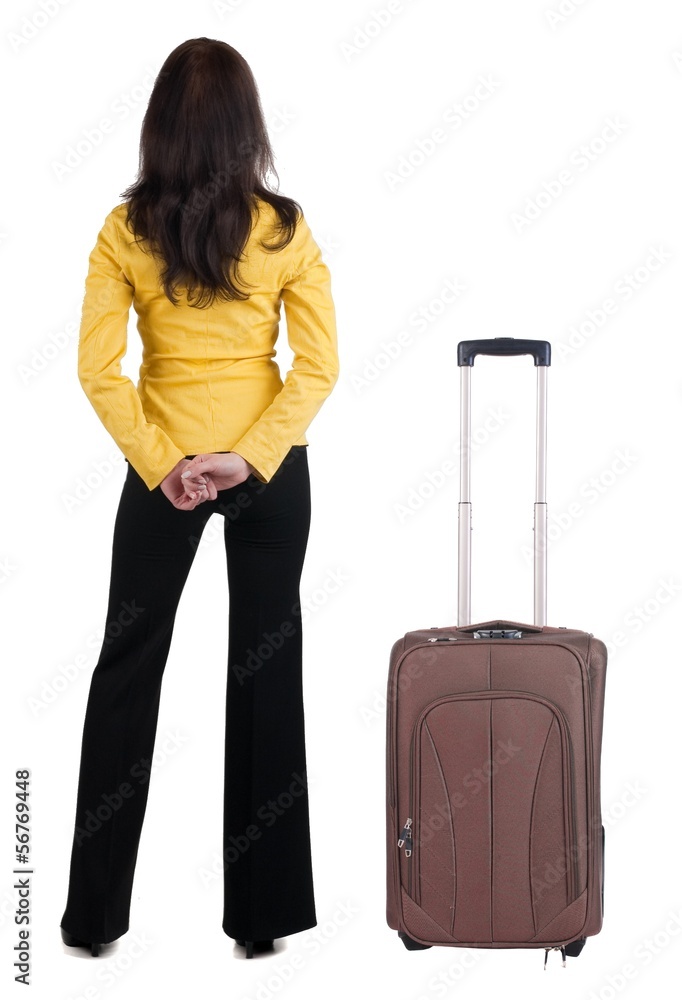 traveling young woman with suitcas in yellow suit looking at w traveling young woman with suitcas in yellow suit looking at w