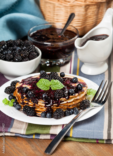 Beautiful delicious pancakes with blackberry on the table