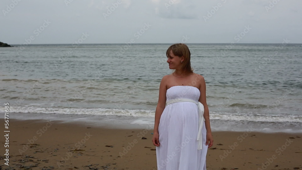 Happy pregnant woman and her husband on the seacoast. Happy pregnant woman and her husband on the seacoast.