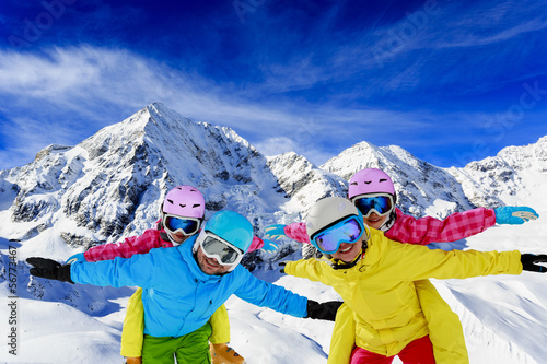 Ski, snow, sun and fun - family enjoying winter