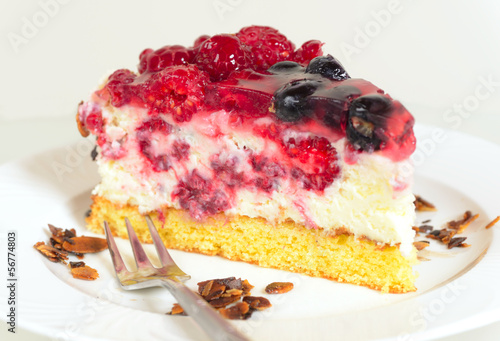 piece of fresh yoghurt cheesecake with berries as a closeup image