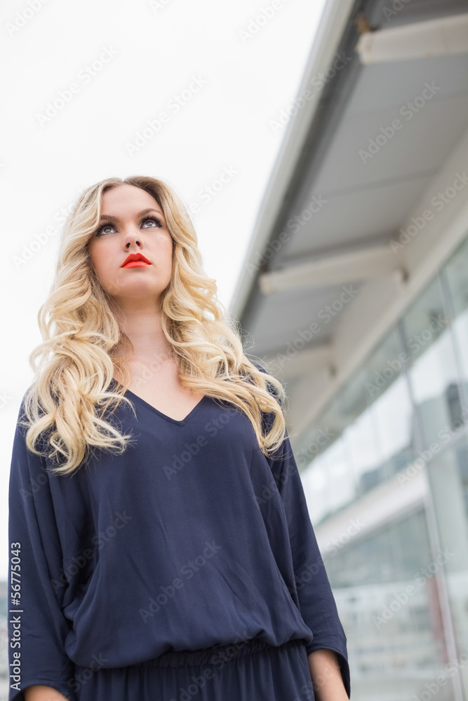 Unsmiling gorgeous blonde with red lips posing outdoors Unsmiling gorgeous blonde with red lips posing outdoors