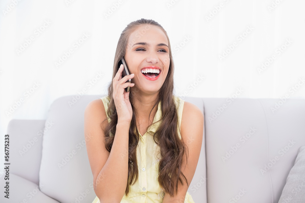 Laughing pretty brunette using mobile phone Laughing pretty brunette using mobile phone