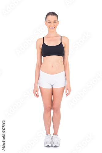 Fit woman wearing sportswear smiling at camera