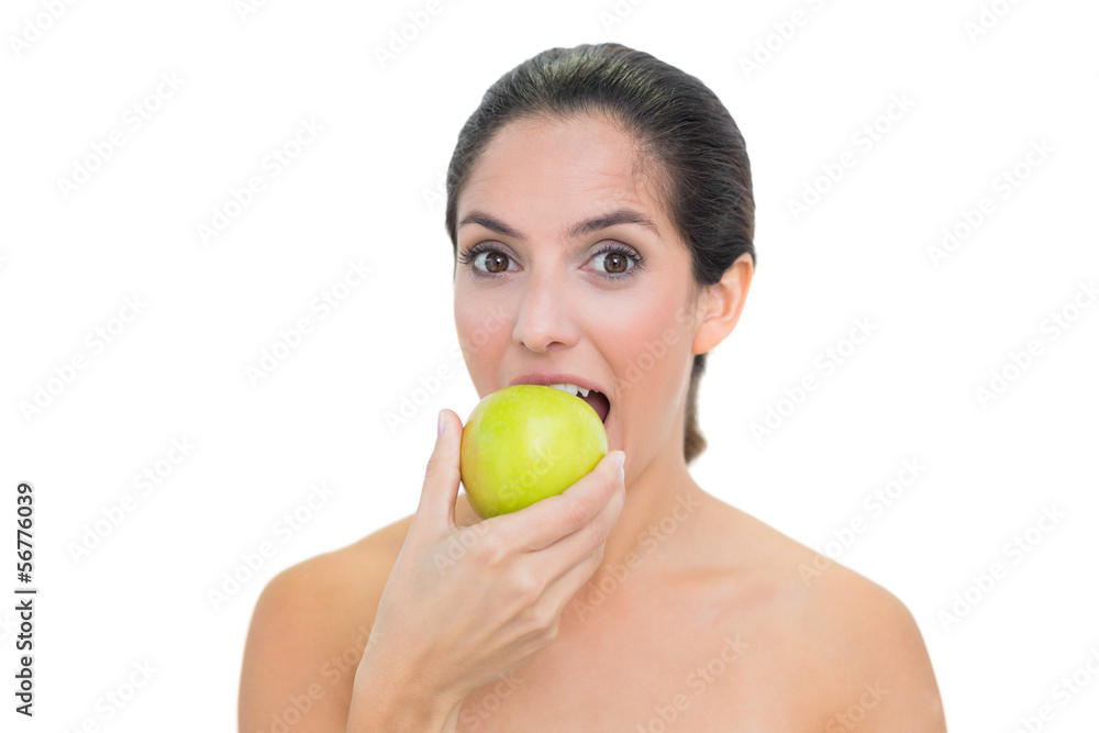Smiling bare brunette eating green apple Smiling bare brunette eating green apple