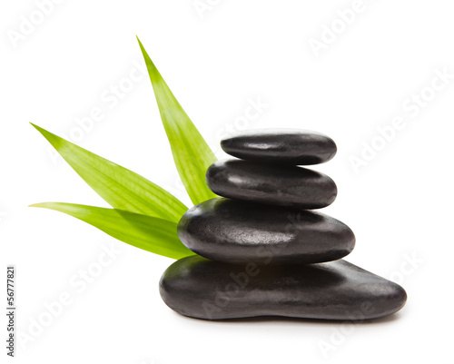 Zen concept - pyramid of black stones and bamboo leaves