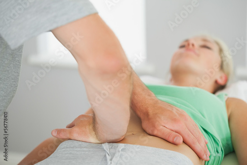 Fotografie Physiotherapist checking patients pelvis alignment