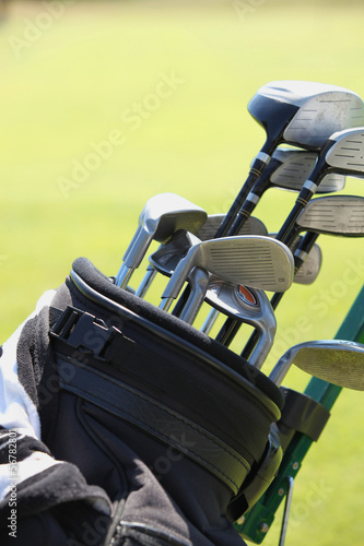 Close up of gold bag and clubs