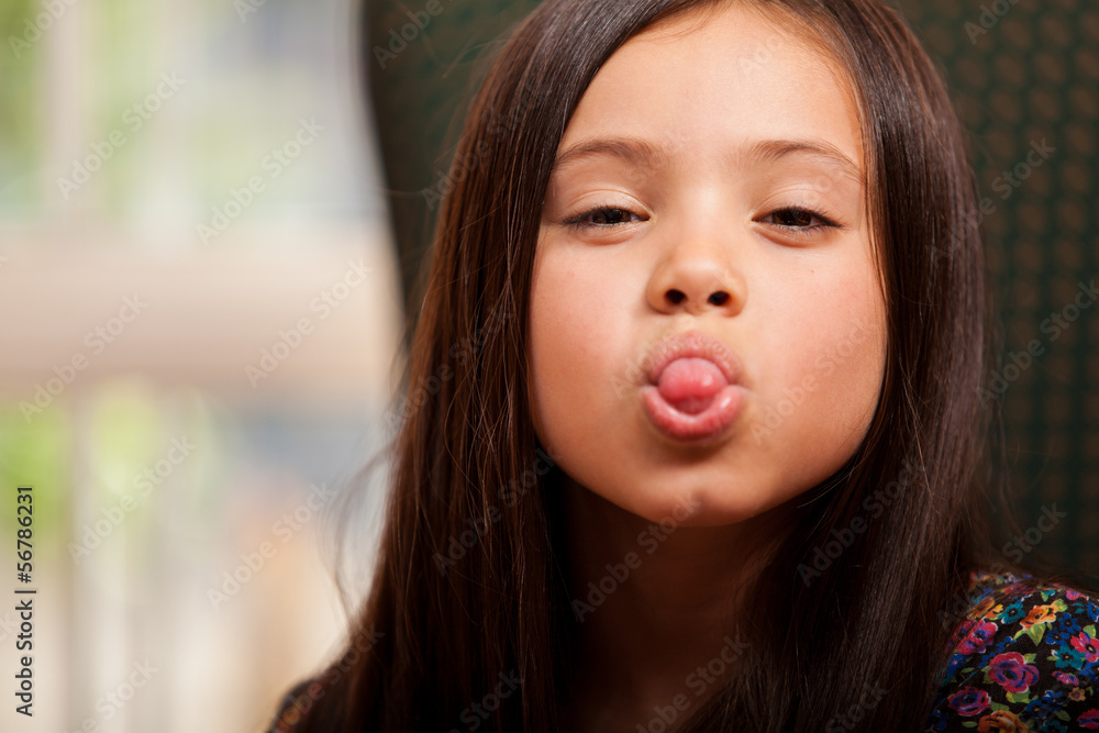 Playful little girl having fun and sticking her tongue out StockFoto