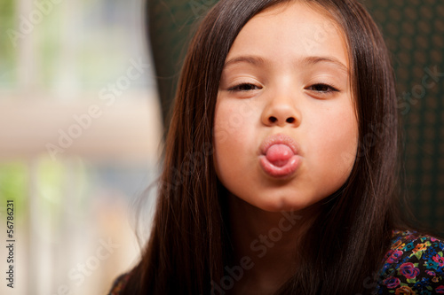 Playful little girl having fun and sticking her tongue out