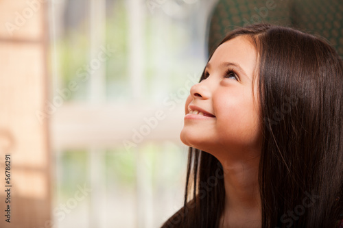Happy little girl looking up