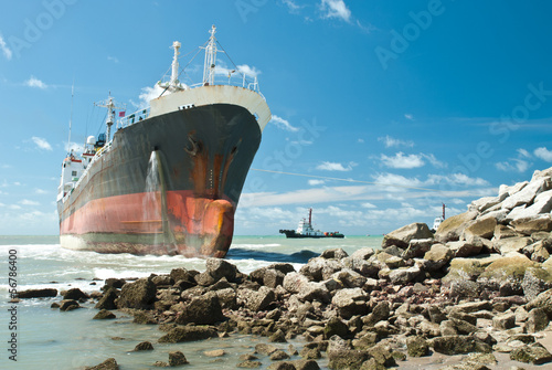 Cargo ship run aground on rocky shore