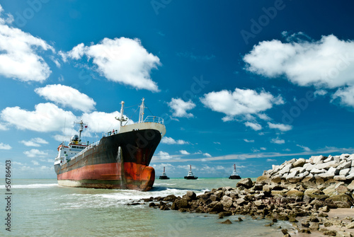 Cargo ship run aground on rocky shore