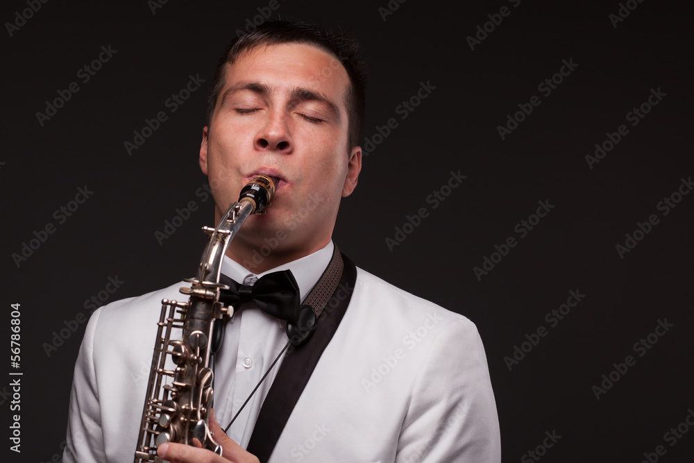 Fototapeta premium Closeup of playing saxophonist. Modern musician