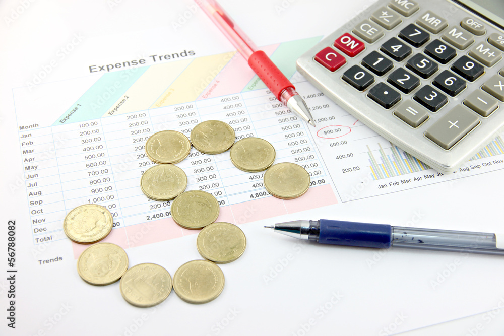 Red Pen,Calculator and money Coins Arranged to 