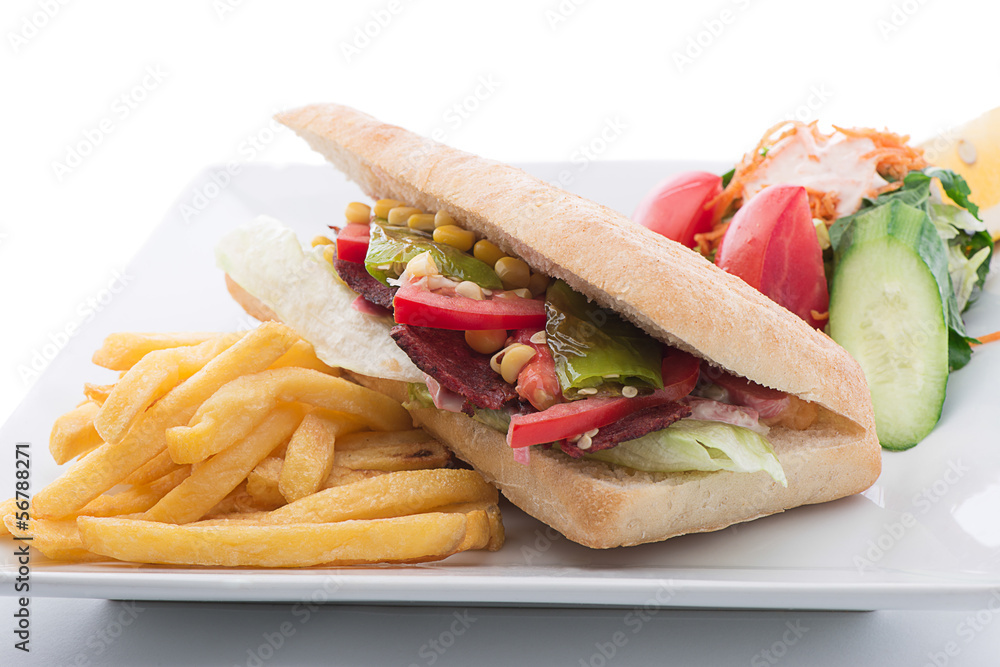 ausage sandwich with salad and french fries on the side ausage sandwich with salad and french fries on the side