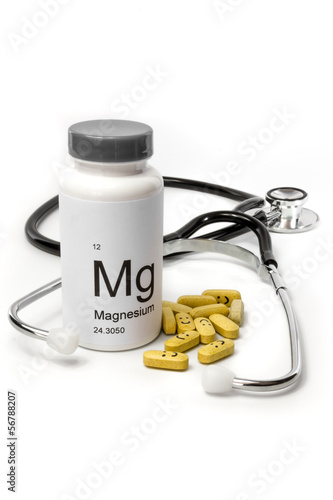 Bottle of Magnesium vitamins with stethoscope photo