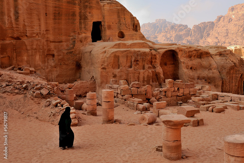 Petra - Jordan - Bedouin woman with a burqa walks among  petra