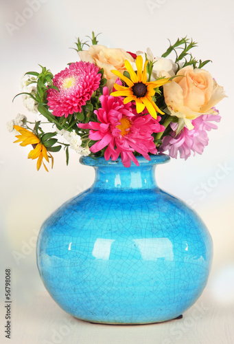 Beautiful bouquet of bright flowers in color vase, © Africa Studio
