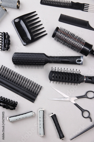 Professional hairdresser tools on gray background