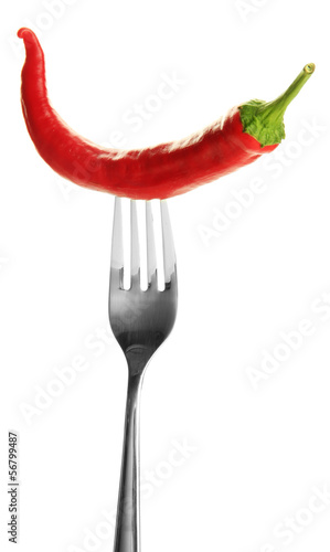 Red hot chili pepper on fork, isolated on white © Africa Studio