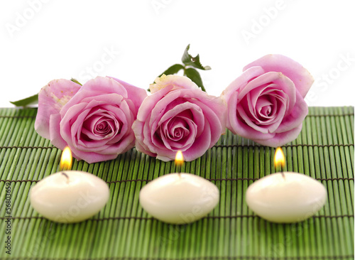 Set of row rose and row candle on green mat