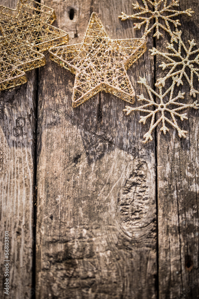 Gold Christmas tree decorations on grunge wood