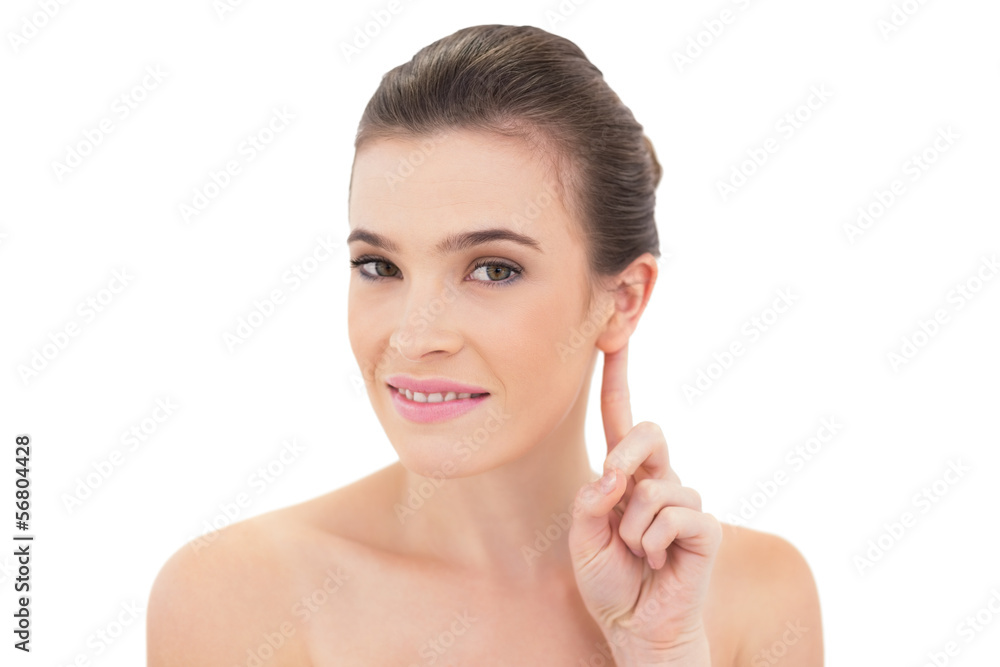 Cute natural brown haired model touching her ear Cute natural brown haired model touching her ear