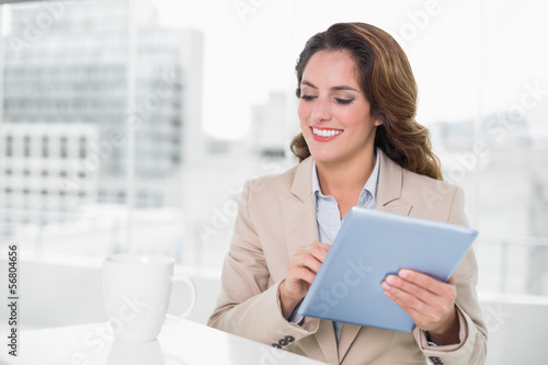 Beautiful happy businesswoman using tablet