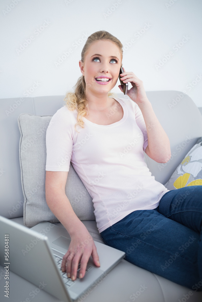 Casual happy blonde phoning and using laptop Casual happy blonde phoning and using laptop
