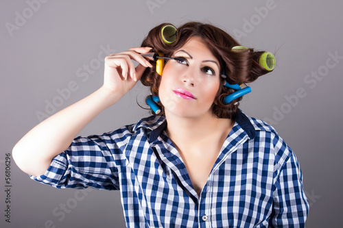young brunette woman applying mascara