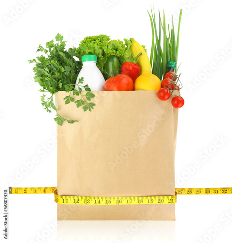 Fresh groceries in a paper bag with measuring tape