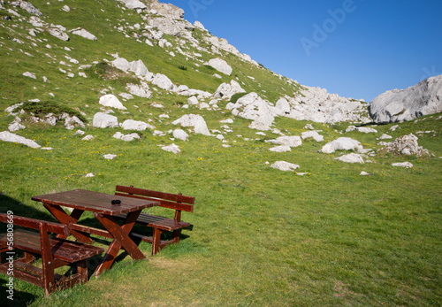 Wooden bench and table in a mountain valley